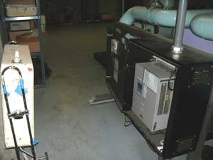 Figure 3: This is a VFD supporting a circulation pump within a chiller plant. The VFD overheated due to lack of ventilation. The operating staff have propped open the enclosure door and placed a residental box fan in front of it in an attempt to cool it.